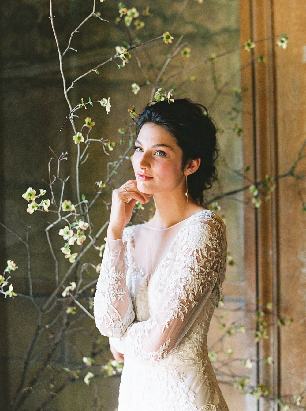 bride in front of flower wall historic mansion wedding, Charlottesville wedding, Riverwood mansion wedding, spring wedding, spring blossoms, long sleeve lace wedding dress