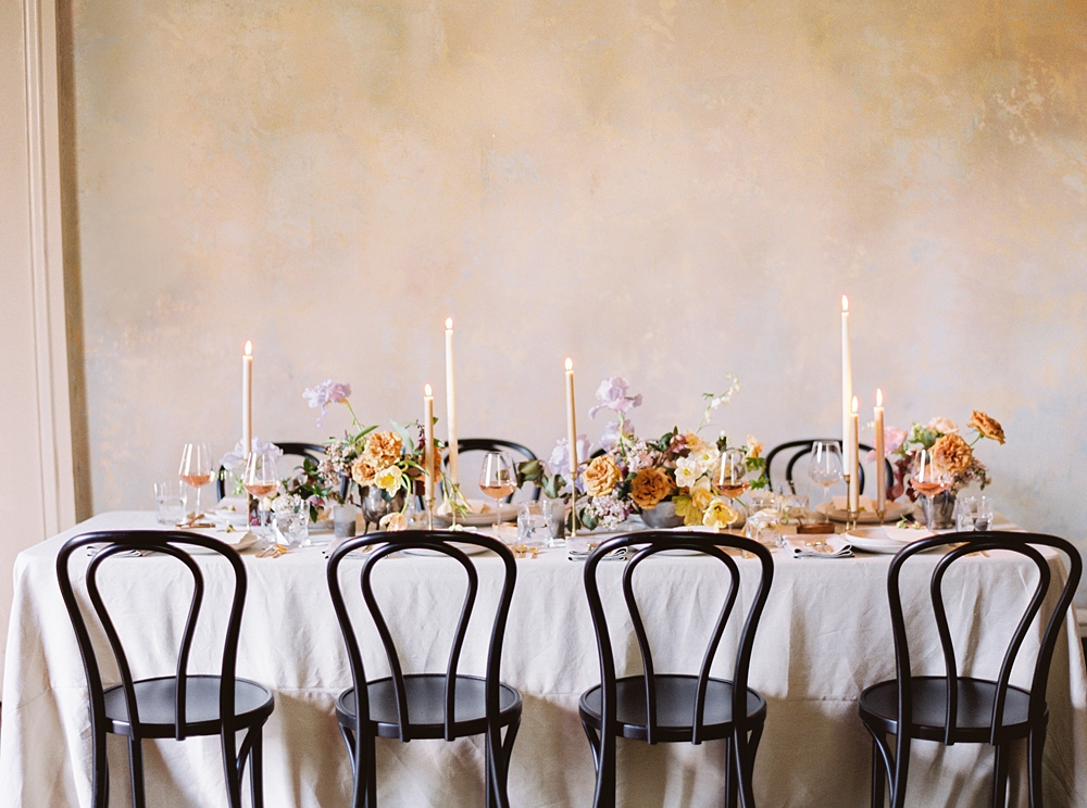 fall wedding tablescape, spring wedding, Charlottesville Virginia wedding photographer, wedding centerpiece, purple yellow pink rust tulips hellebore wedding flowers, black wedding chairs, wedding reception table decor
