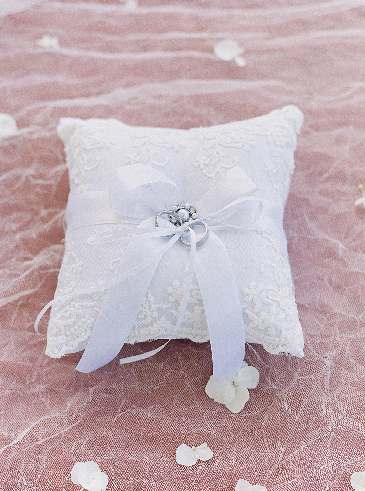 Wedding ring pillow with blue ribbon on pink background , wedding and engagement rings