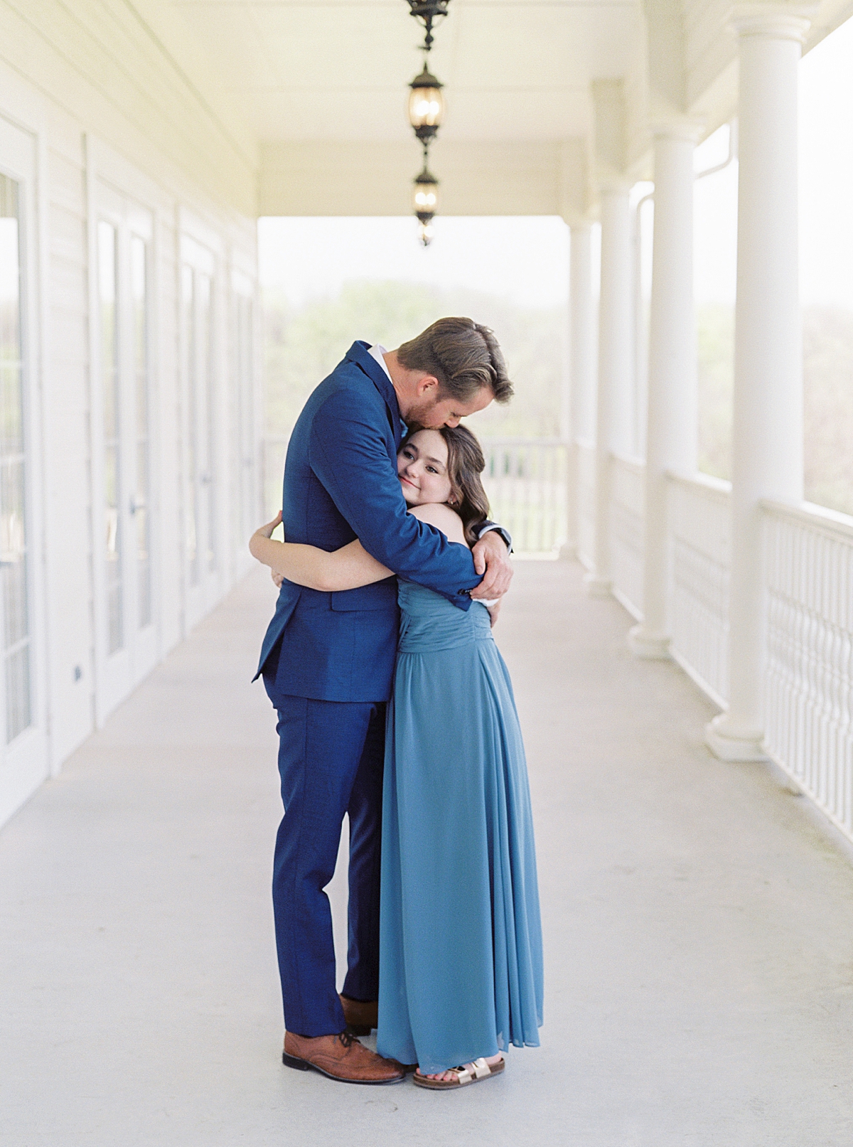Groom hugging daughter on wedding day, mansion wedding, family wedding photos