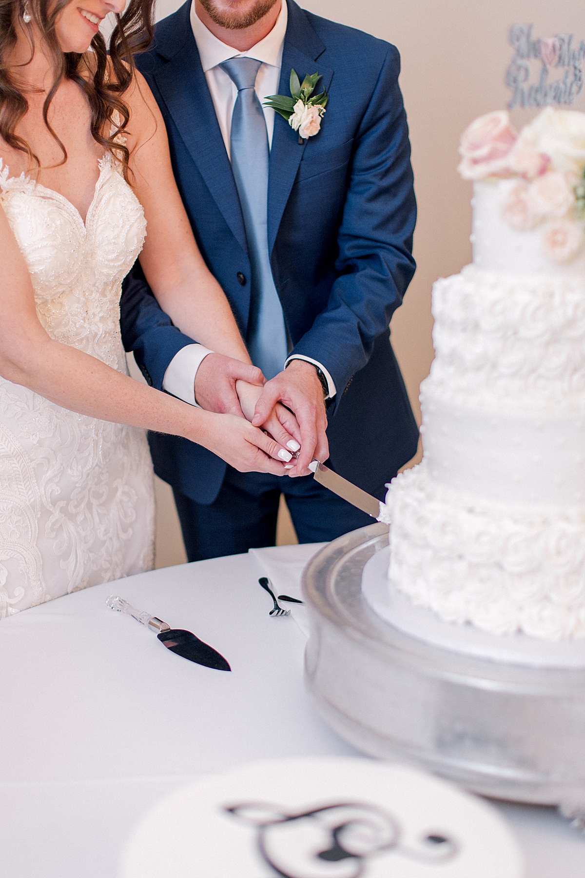 Bride and groom cutting wedding cake during wedding reception