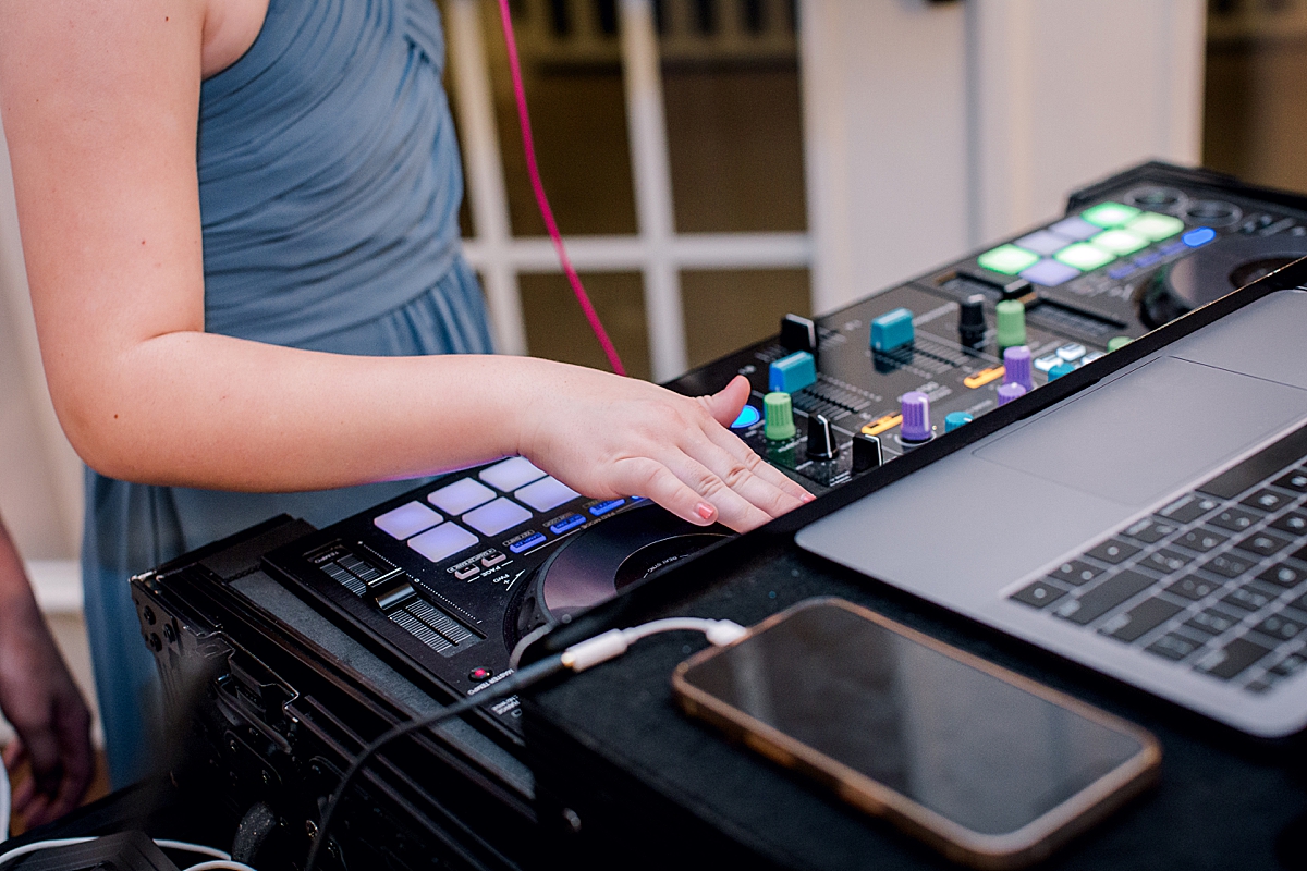 Groom's daughter practices being a DJ at wedding reception