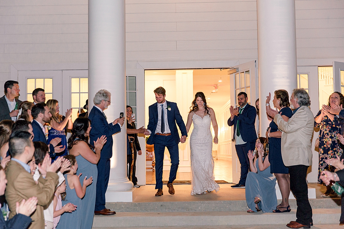 Bride and groom exit during grand send off from wedding reception
